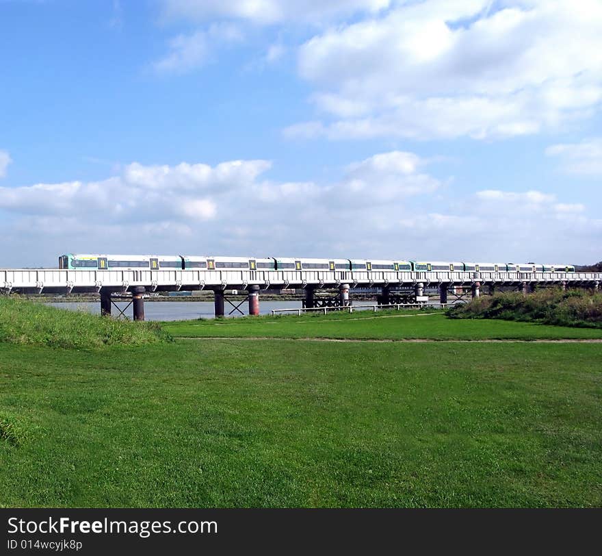 Landscape of commuter train crossing a river