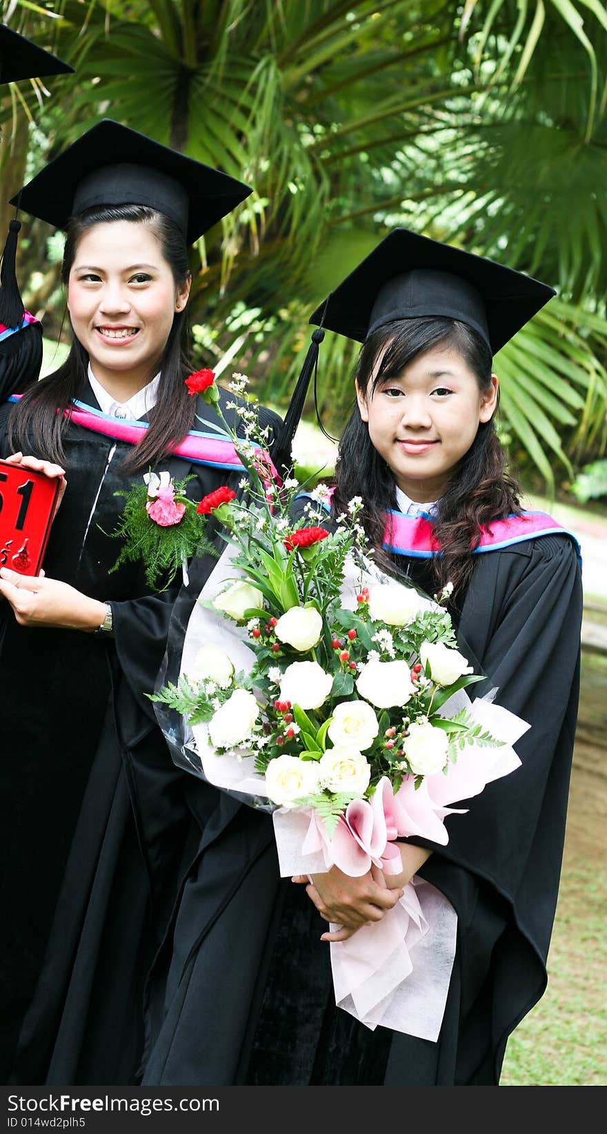 Gorgeous Asian university graduates celebrating their success.