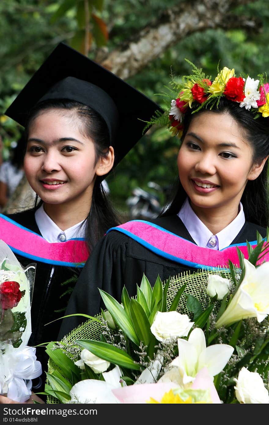 Gorgeous Asian university graduates celebrating their success.