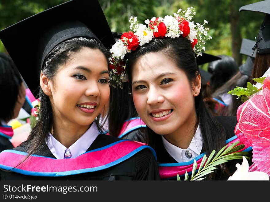 Gorgeous Asian university graduates celebrating their success.