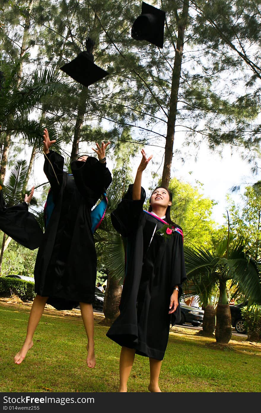 Gorgeous Asian university graduates celebrating their success.