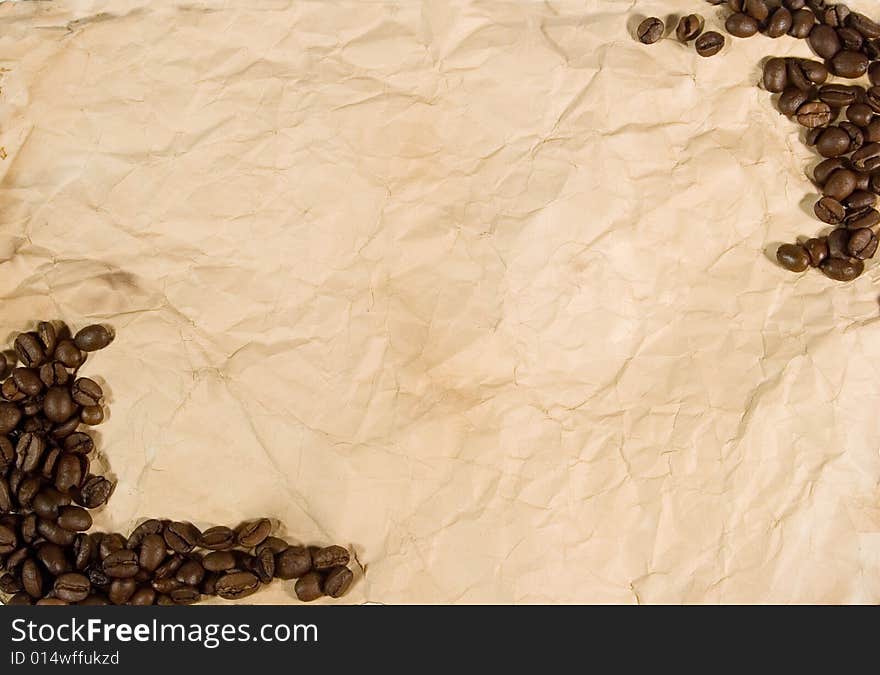 Coffee beans on old crumpled paper