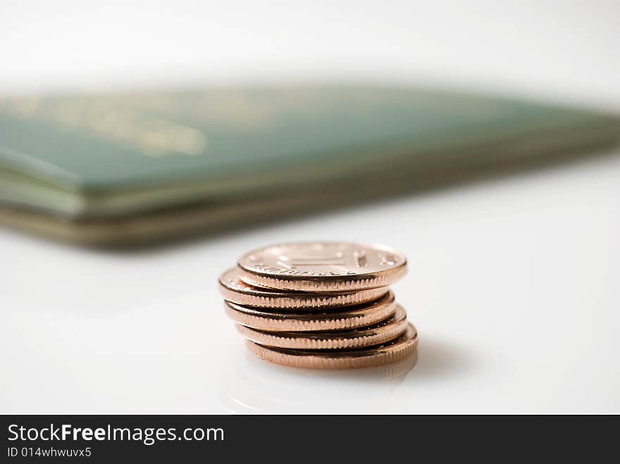 Passport and ten-centevo coins on white background