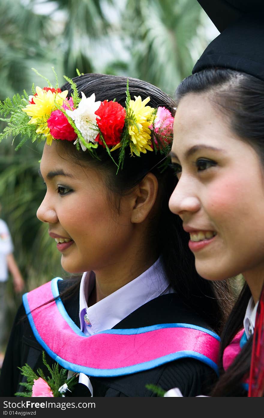 Gorgeous Asian university graduates celebrating their success.