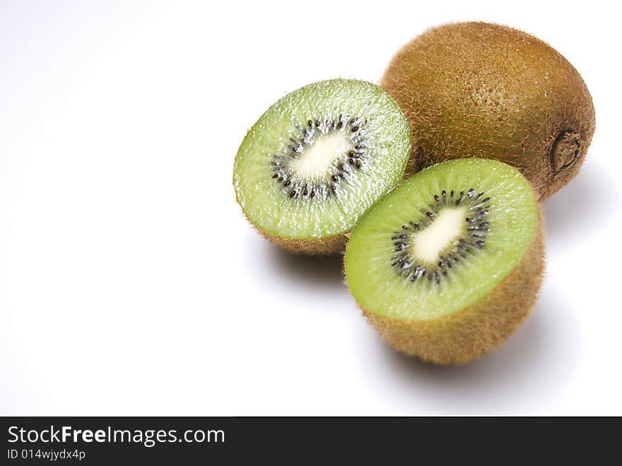 Whole and sliced kiwi fruit on white background