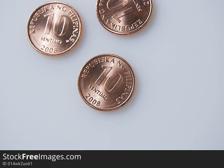 Ten-centavo Philippine coins on white background