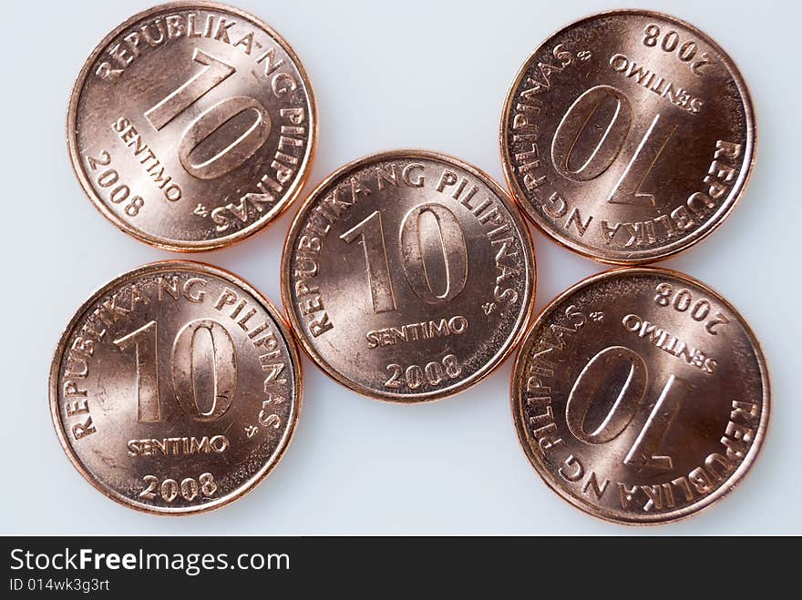 Ten-centavo Philippine coins on white background