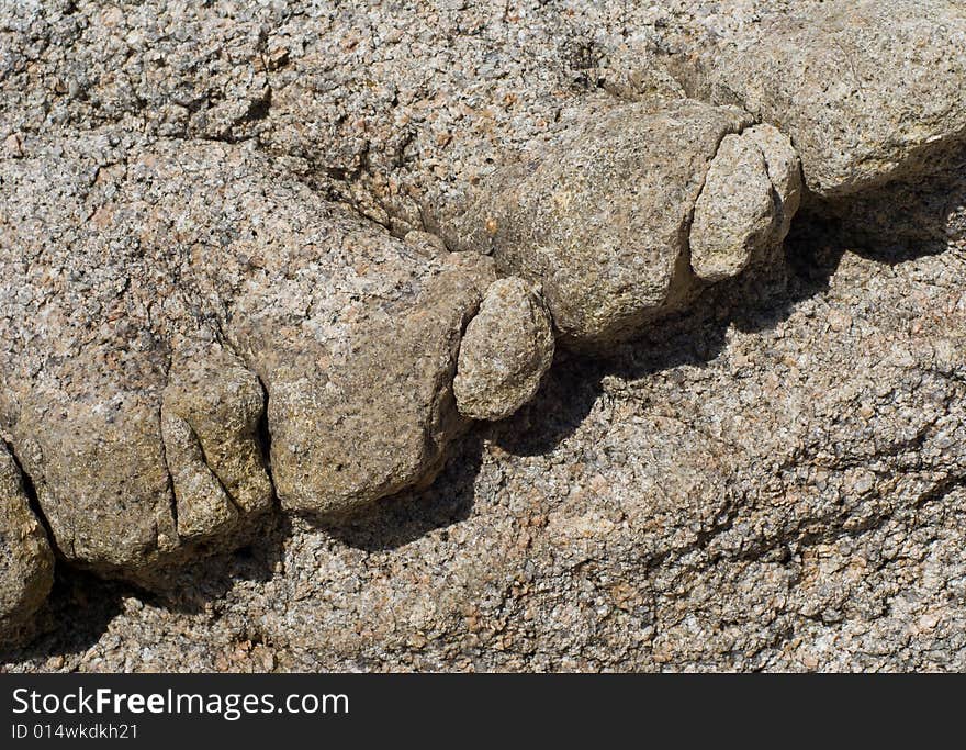 A close-up of a surface of very rough and granulated stone at seacoast. A close-up of a surface of very rough and granulated stone at seacoast.