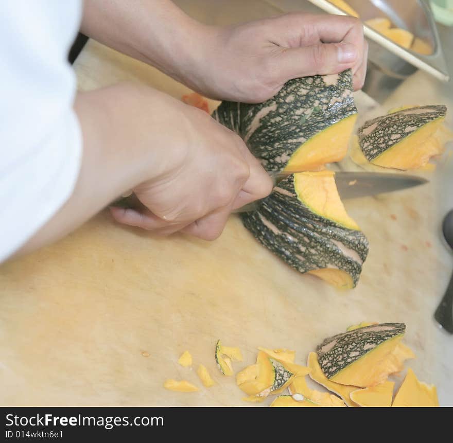 Chef cutting pumpkin