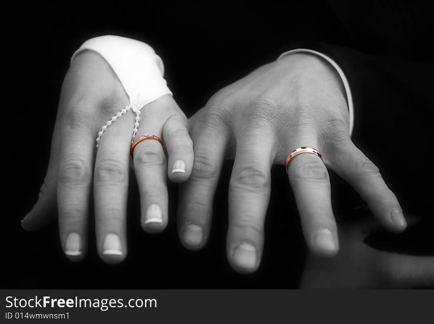 Color gold rings on the hands. Black and white photo