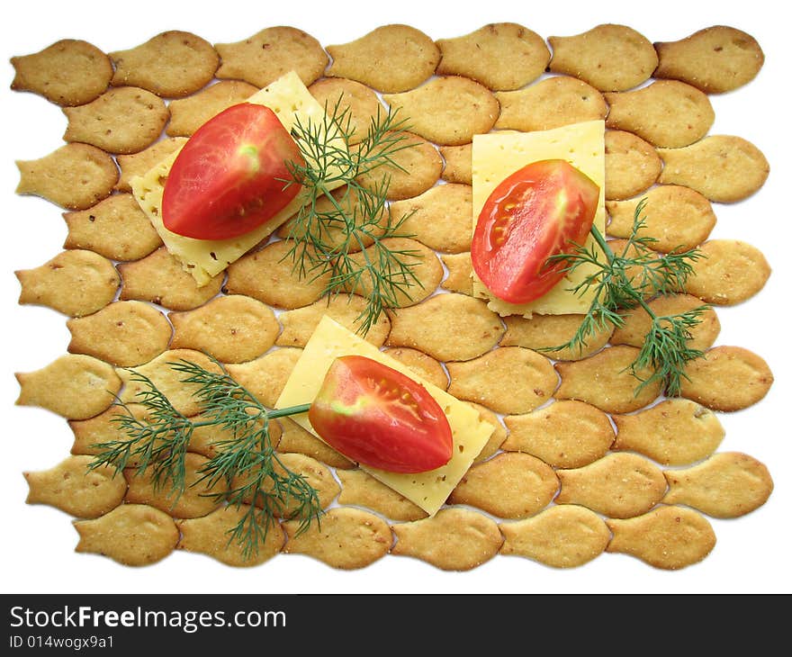 Tomato pieces on cheese slices and cracker. Tomato pieces on cheese slices and cracker