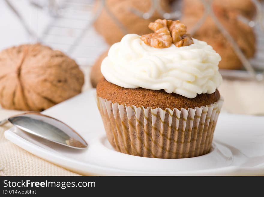 Walnuts muffins with mascarpone cheese (whipped cream).