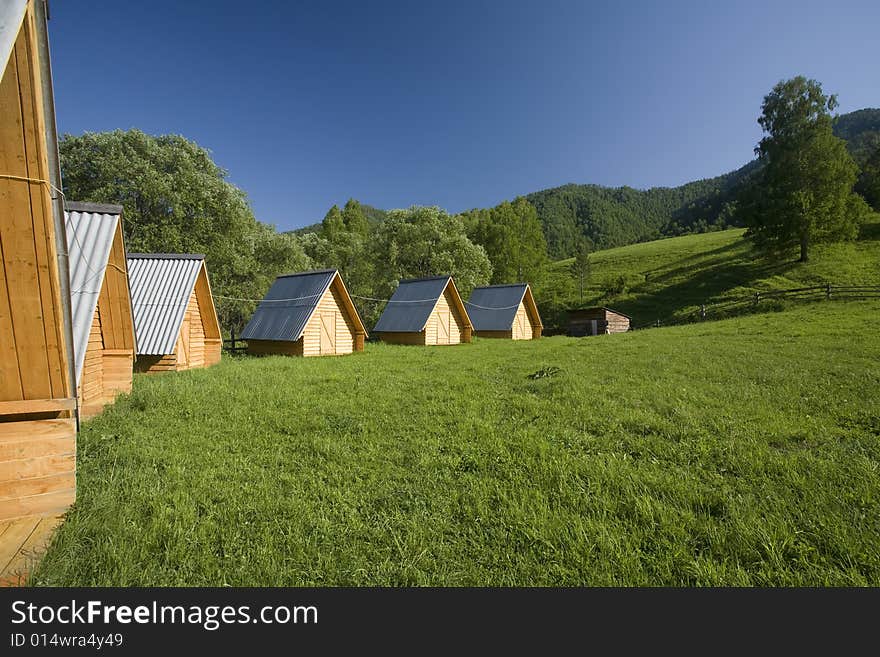 Summer tourist camp, small houses on a green field