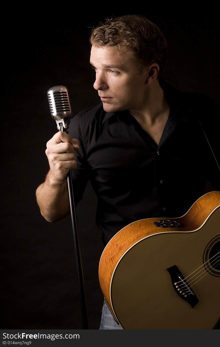 Young musician playing a guitar and singing