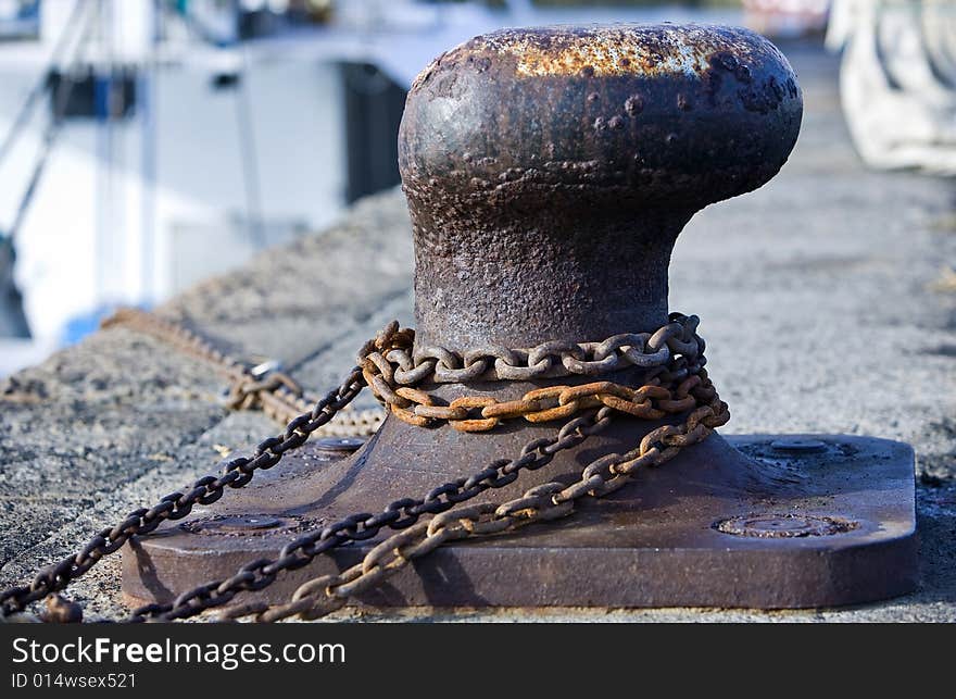 Close up of iron mooring with rusty chain