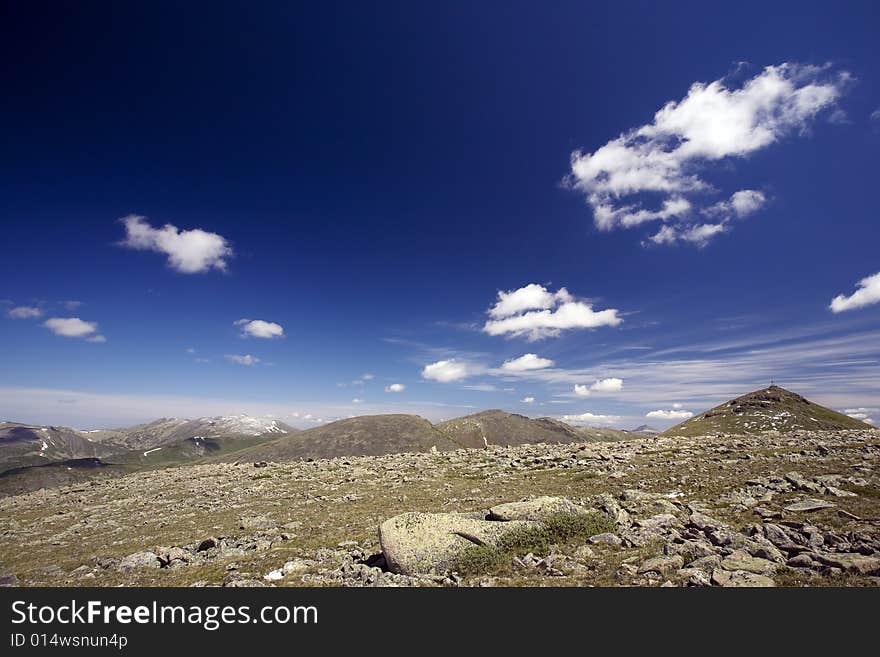 High mountain's rocks, summer, sky and clouds. High mountain's rocks, summer, sky and clouds