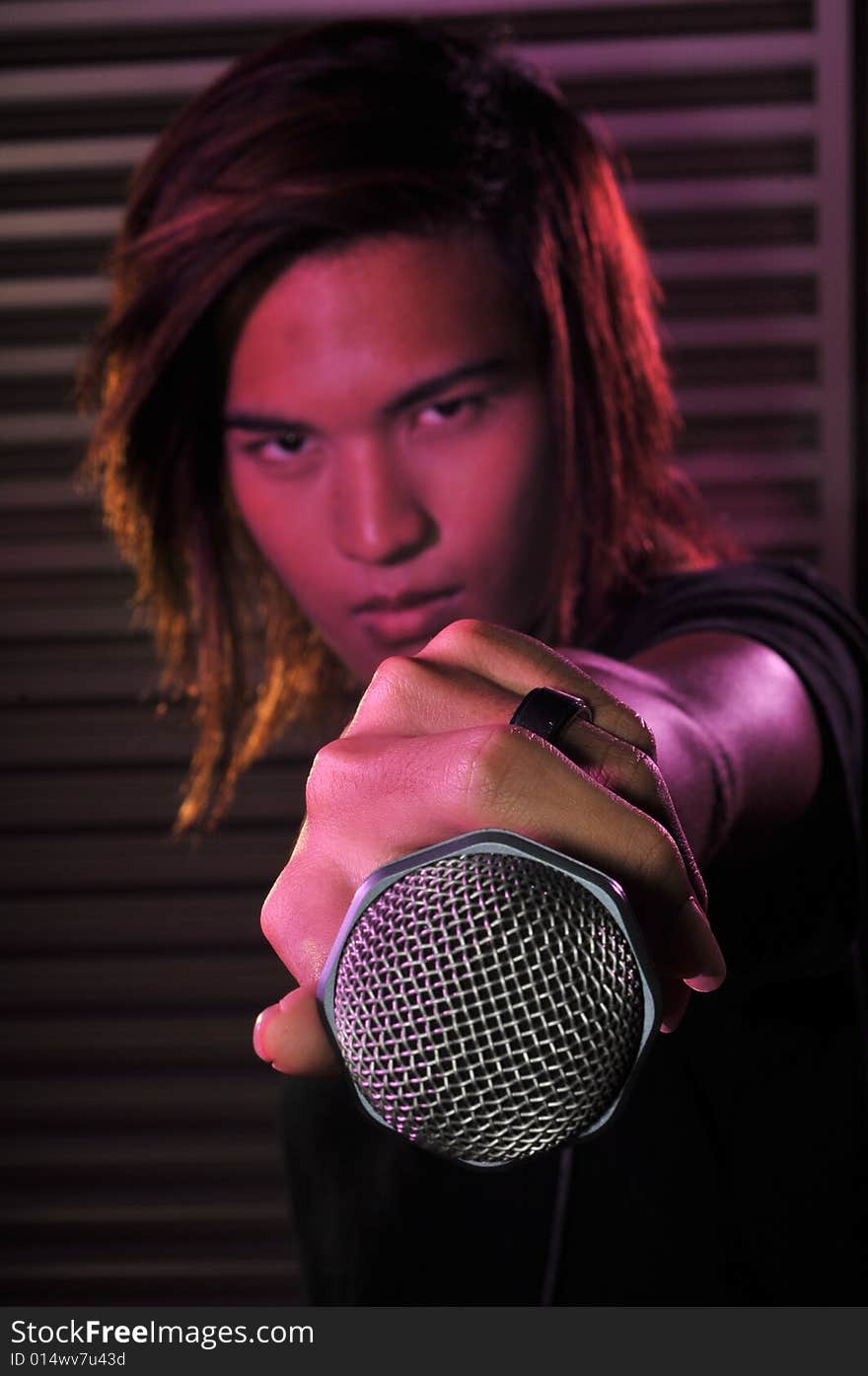 Picture of a young generation rock star with a microphone. Suitable for musical related contexts. Picture of a young generation rock star with a microphone. Suitable for musical related contexts.