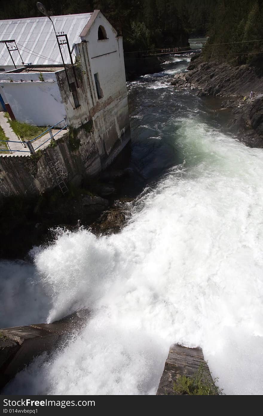 Hydroelectric power station building, summer, water flow