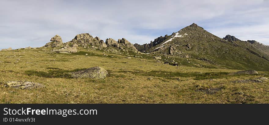 Panoramic picture in high mountains, summer, blue sky and white clouds