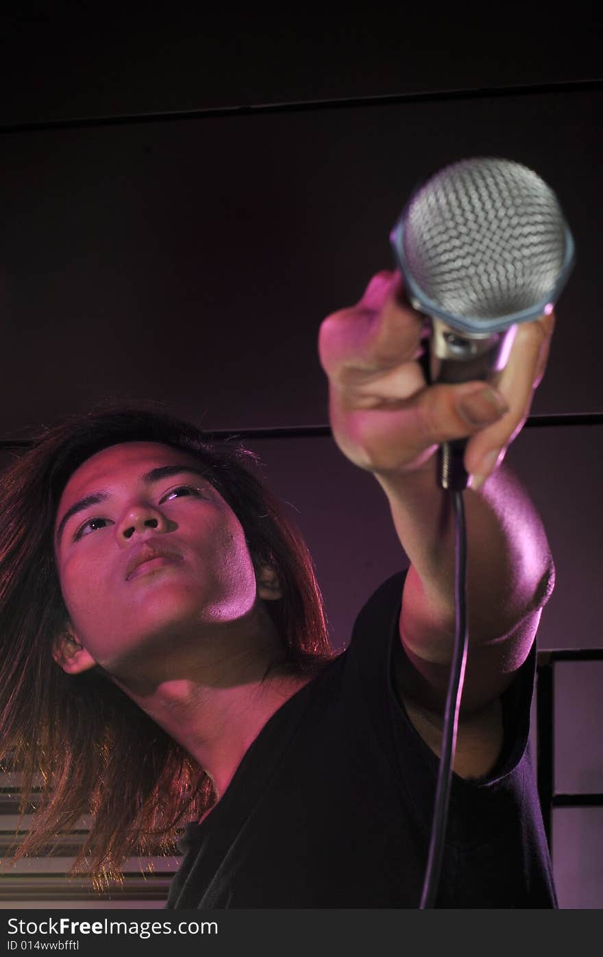 Picture of a young generation rock star with a microphone. Suitable for musical related contexts. Picture of a young generation rock star with a microphone. Suitable for musical related contexts.