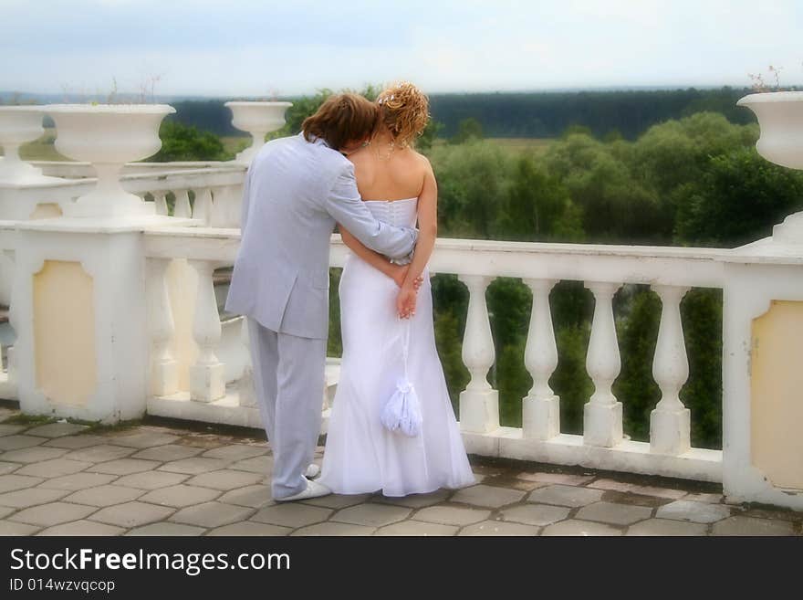 Fiance and bride walking. White column. Soft focus. Fiance and bride walking. White column. Soft focus