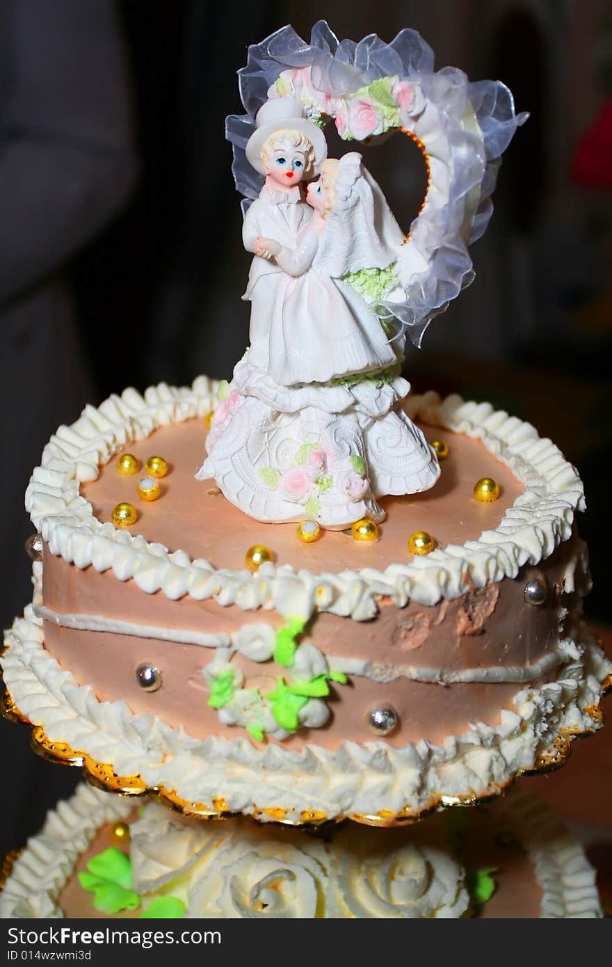 Bride and fiance on the top of the cake. Bride and fiance on the top of the cake