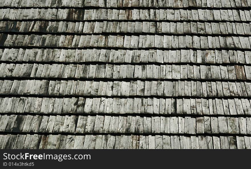 A fragment of withered wooden shingles upon an ancient watchtower