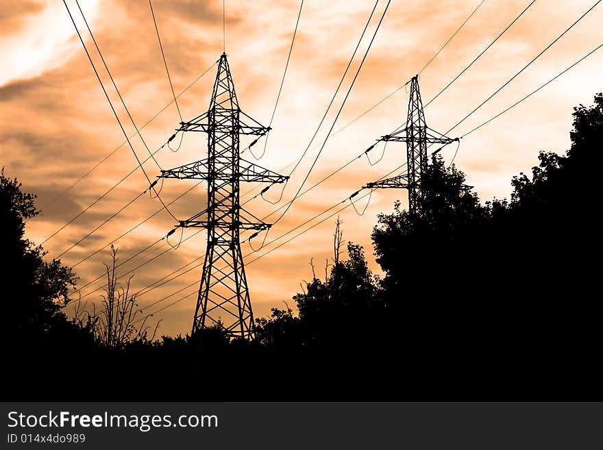 Power lines and electric pylon on a background of sky