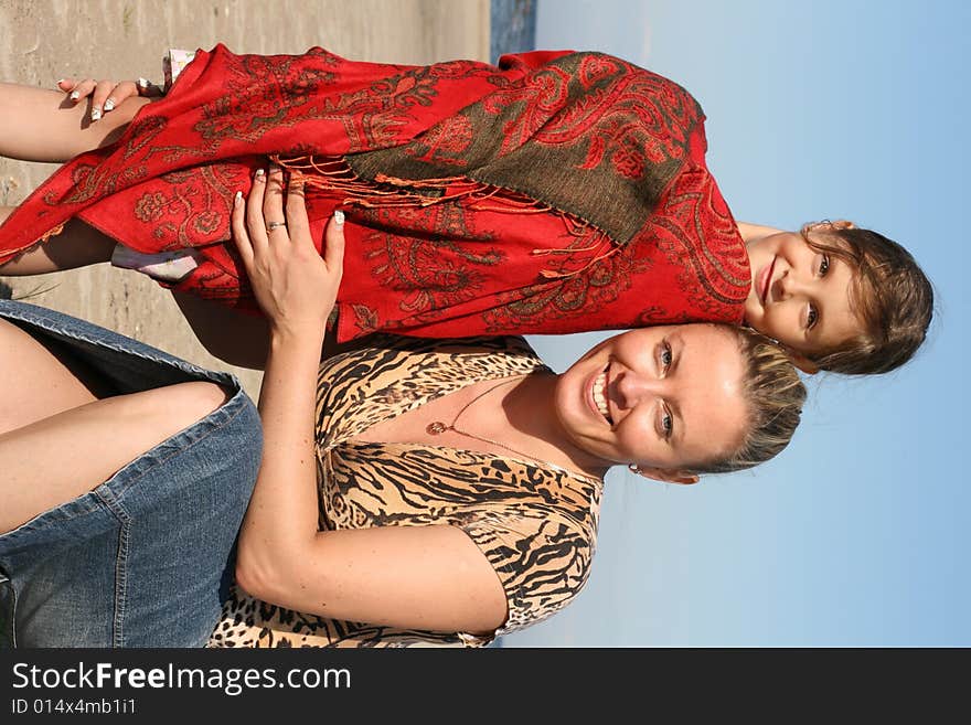 Smiling little girl and her mother. Smiling little girl and her mother