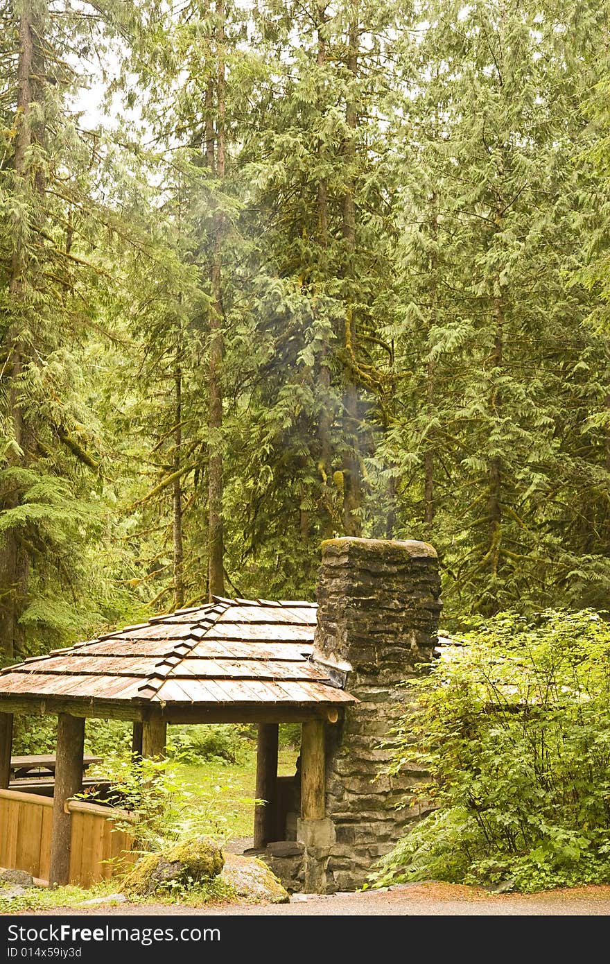 A rustic camp site in the wilderness with a stone fireplace. A rustic camp site in the wilderness with a stone fireplace