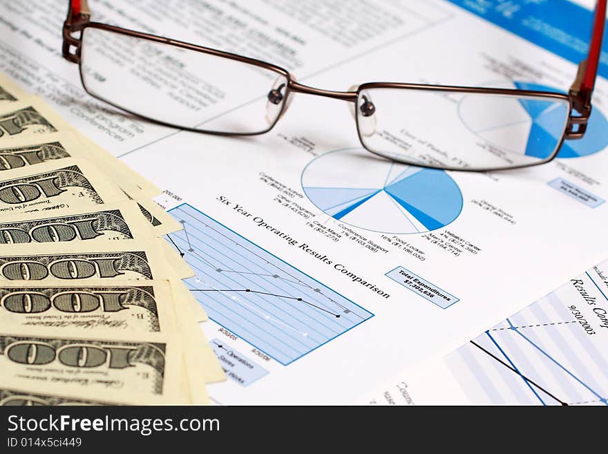 A pair of glasses on top of a financial report.