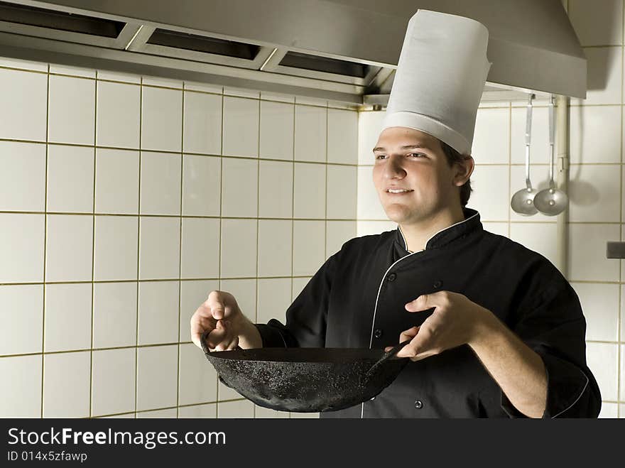 Smiling chef carrying a wok. Horizontally framed photo. Smiling chef carrying a wok. Horizontally framed photo.