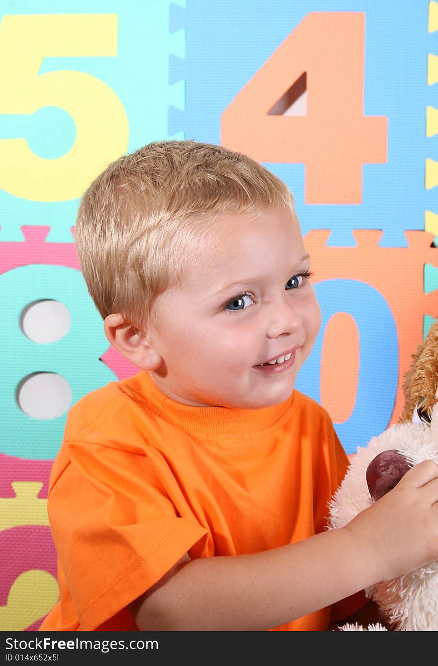 Blond Toddler playing against a colorful background. Blond Toddler playing against a colorful background