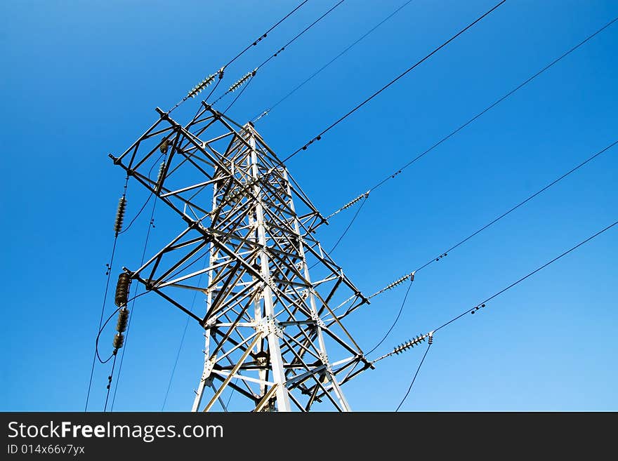 Power lines and electric pylon on a background of sky