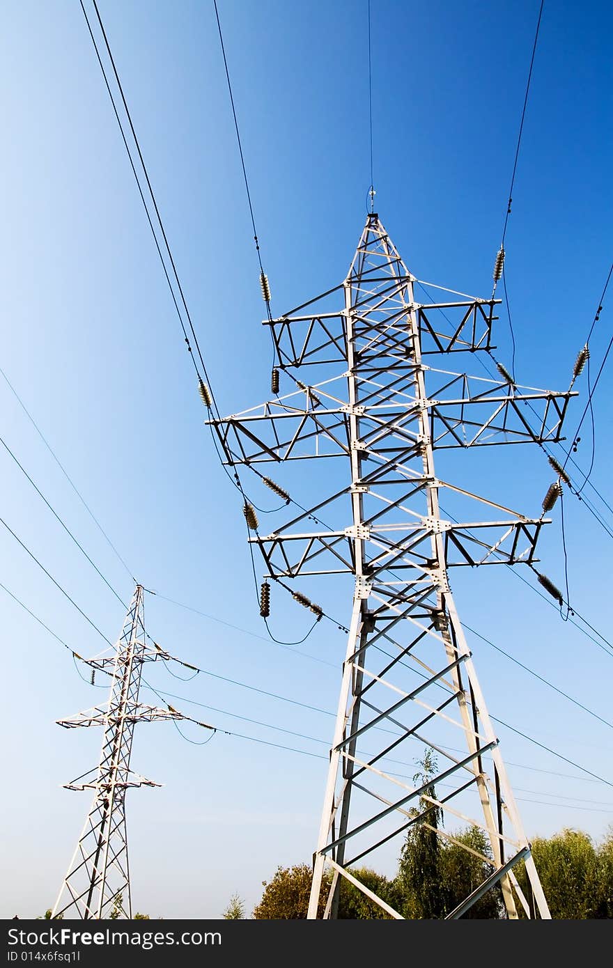 Power lines and electric pylon on a background of sky