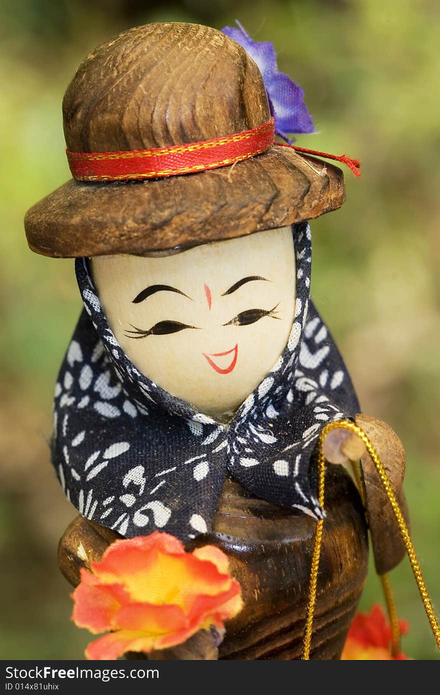 The wooden doll smiling to you .