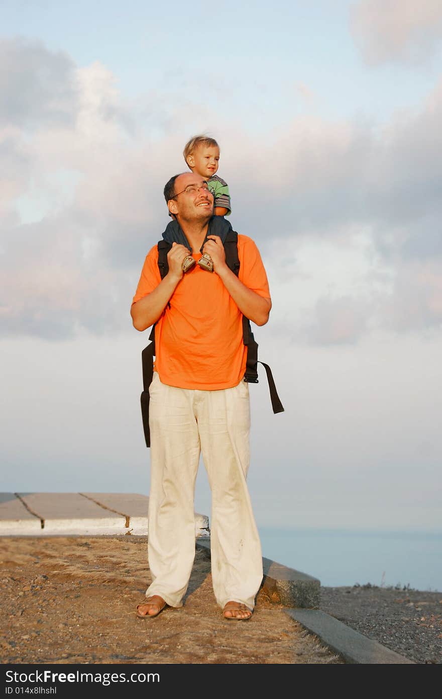 Father and son on sky background