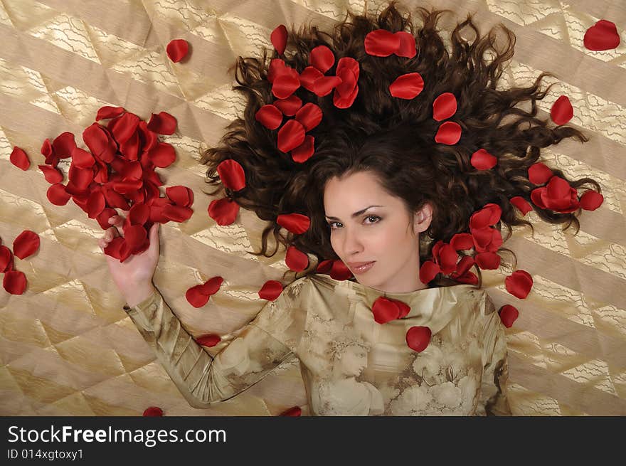 Woman With Petal On Golden Background