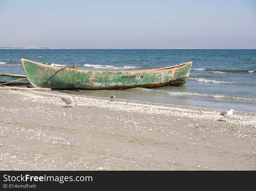 Green boat on the beach