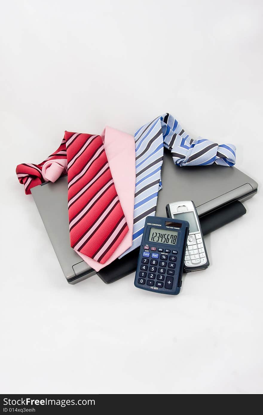 Laptop and tie on a white background