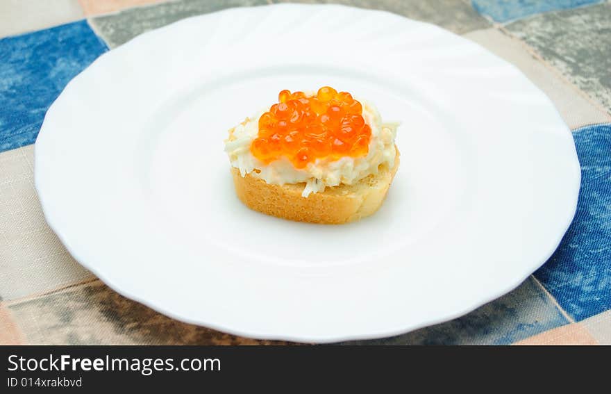 Caviar sandwich on white plate