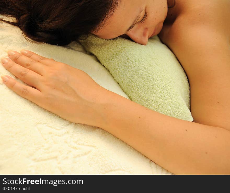 Concept of spa - female laying over towels