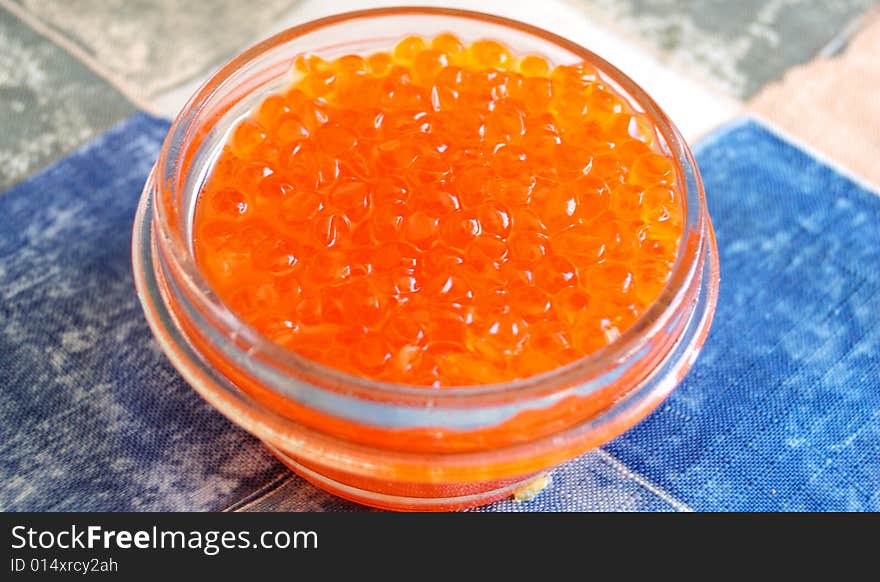 Glass jar full of salmon caviar