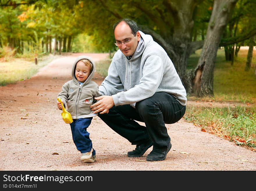 Father and son in autumn park