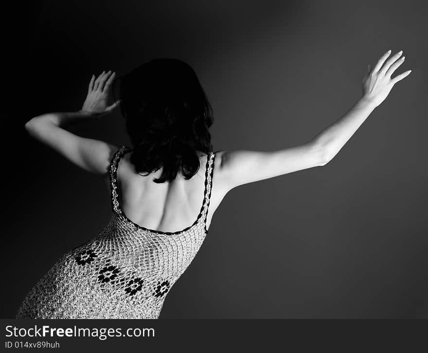 Portrait of young fashion woman wearing a dress - back view. Portrait of young fashion woman wearing a dress - back view