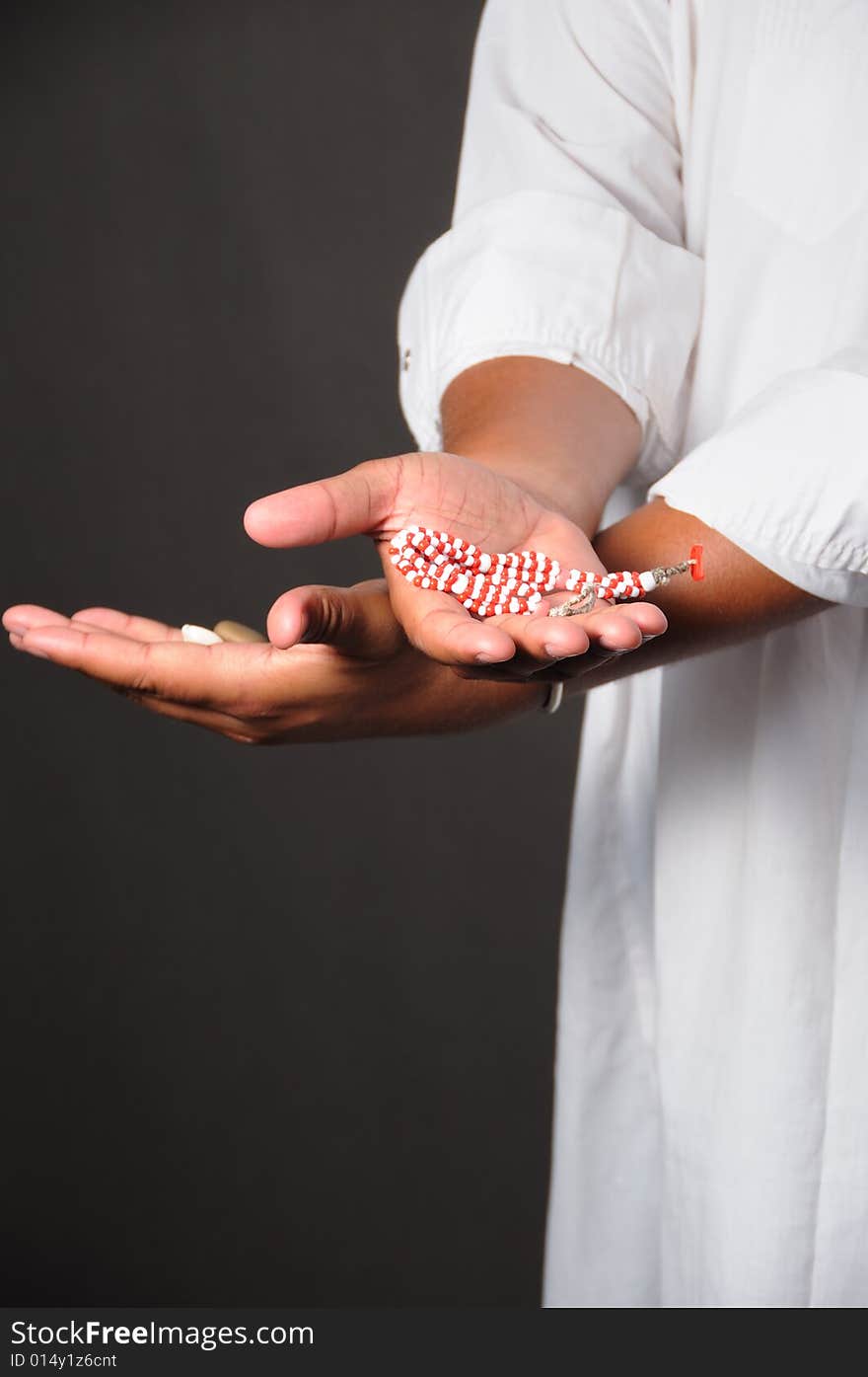 Detail of human hands holding afrocuban religious charm. Detail of human hands holding afrocuban religious charm