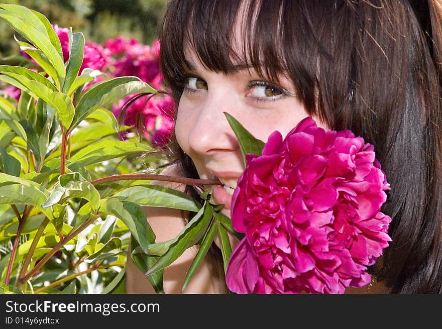 Pretty girl takes flower in her teeth. Pretty girl takes flower in her teeth