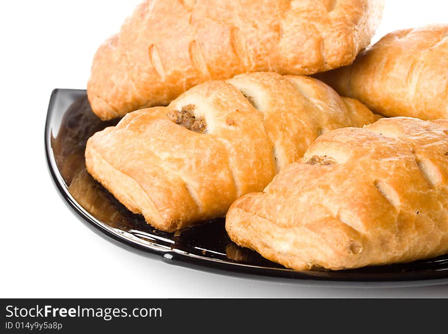 Fresh rolls on a plate on a white background