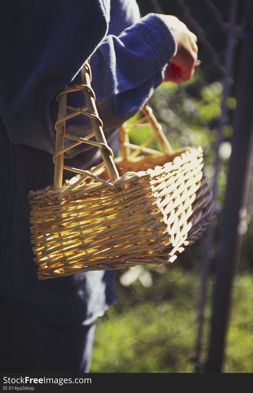 Woman carrying empty garden basket