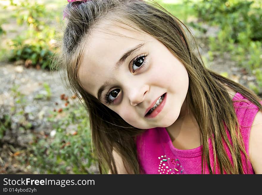 Big Brown eyes, closeup, and a beautiful child dressed in pink with long brunette hair. Big Brown eyes, closeup, and a beautiful child dressed in pink with long brunette hair.